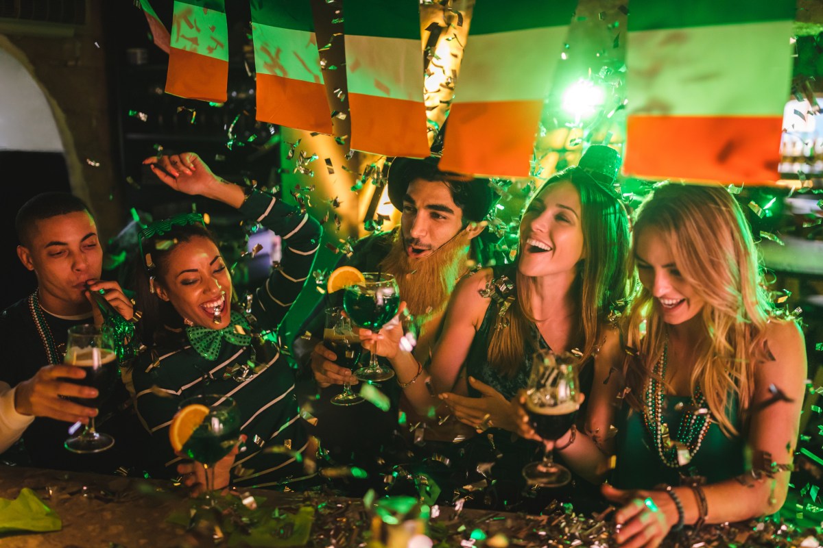 Friends partying with drinks and confetti on Saint Patrick’s day